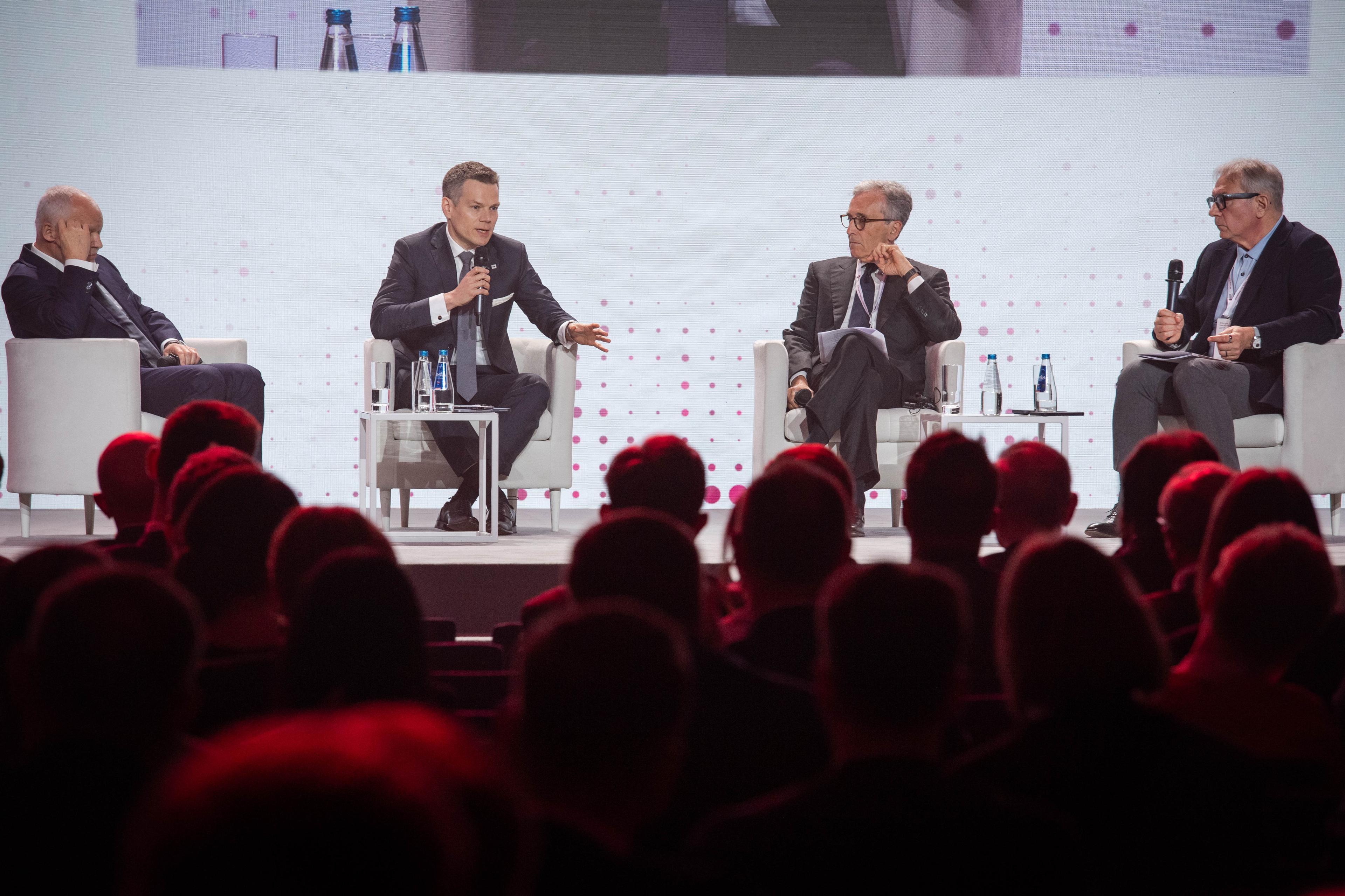Jacek Jastrzębski speaks to microphone on stage