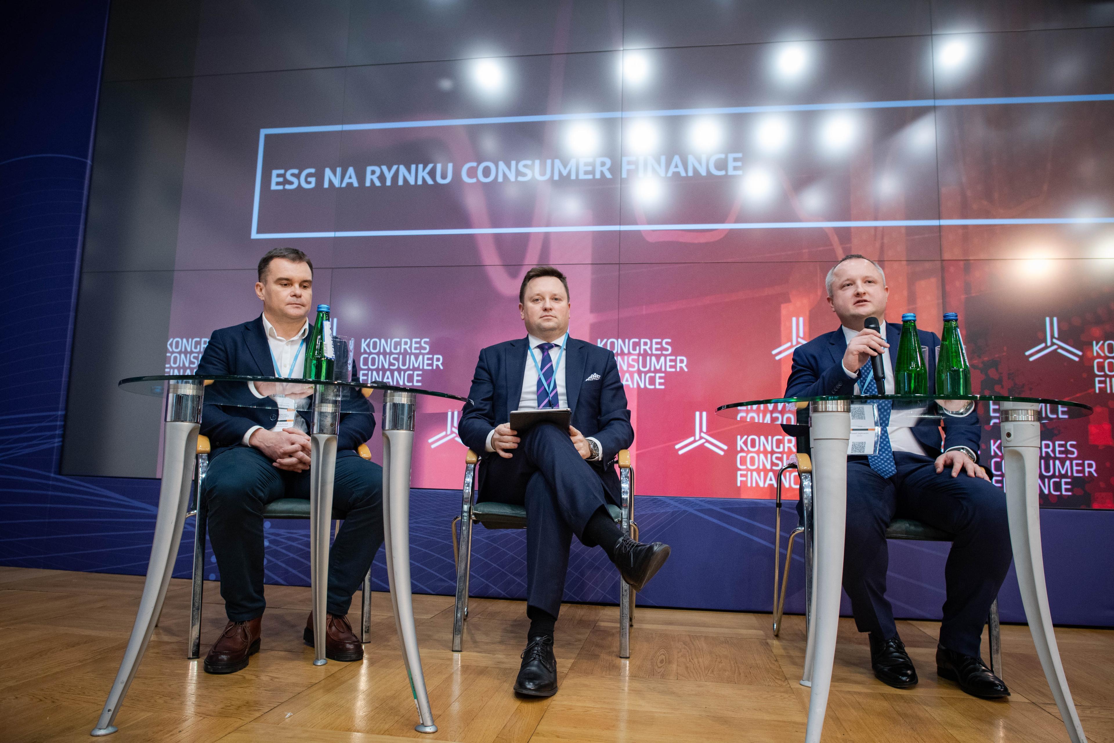 Kamil Liberadzki on stage with debate participants